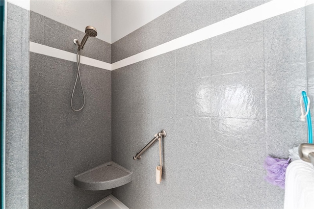 bathroom with tiled shower