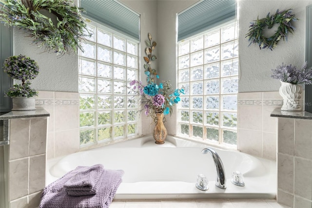 bathroom with a relaxing tiled bath