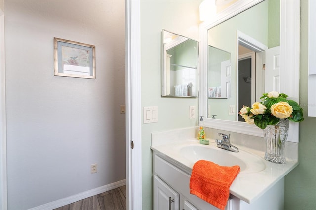 bathroom featuring hardwood / wood-style floors and large vanity