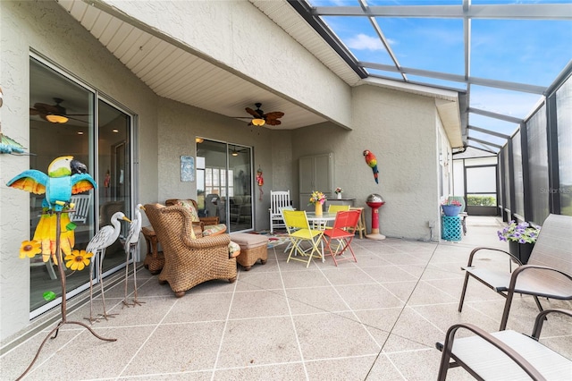 view of patio featuring glass enclosure and ceiling fan