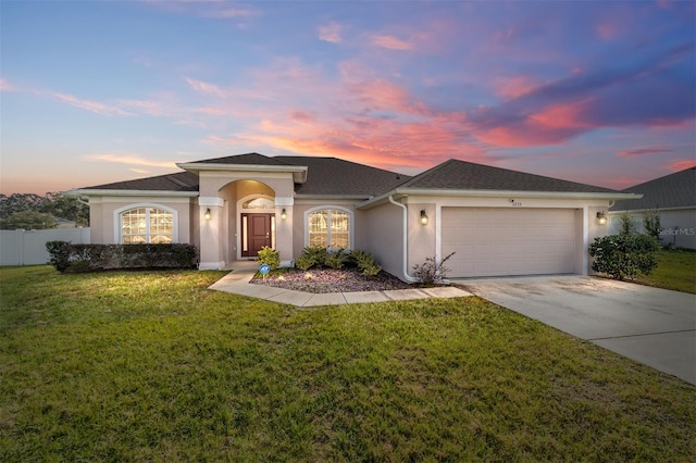 view of front of home with a lawn and a garage