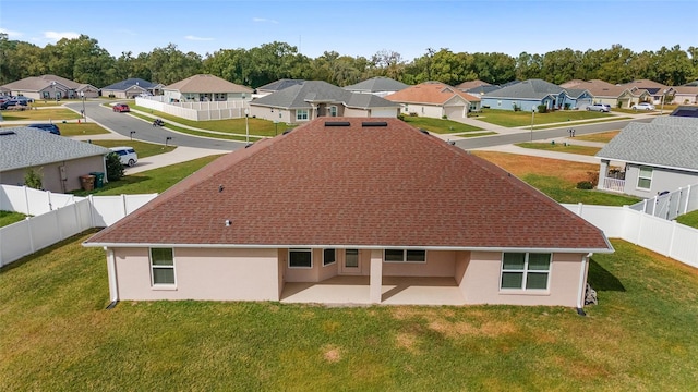 back of house featuring a lawn