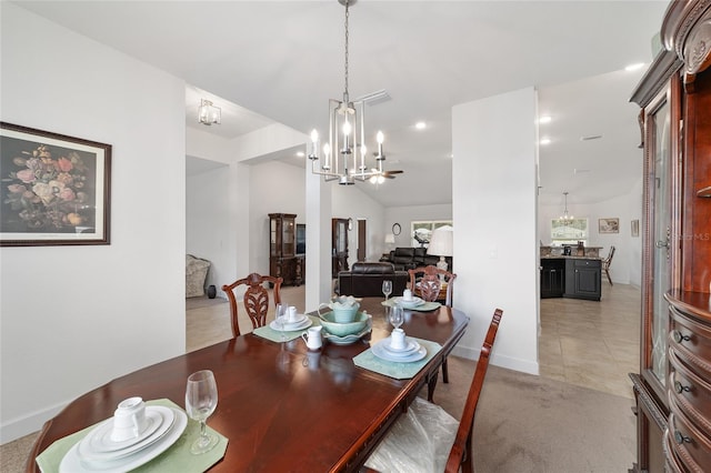 carpeted dining area with a chandelier and lofted ceiling