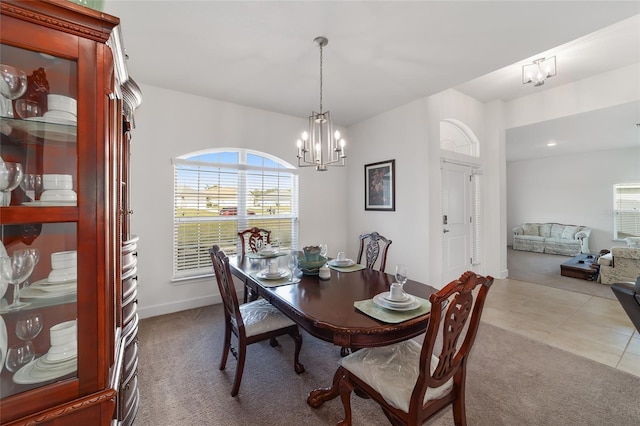 tiled dining area with a notable chandelier