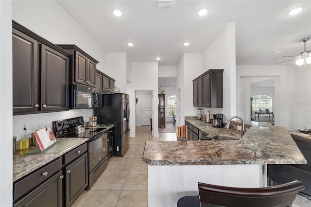 kitchen featuring black appliances, ceiling fan, a healthy amount of sunlight, and light tile floors