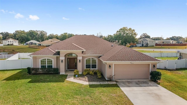 view of front of property with a front yard and a garage