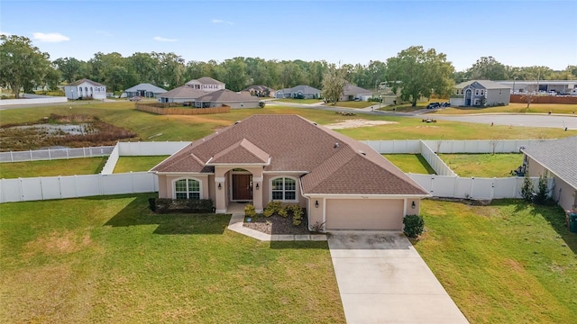 view of front of home featuring a front lawn and a garage