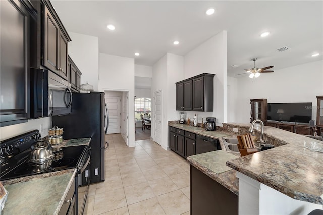 kitchen featuring light tile floors, dark stone counters, ceiling fan, black appliances, and sink