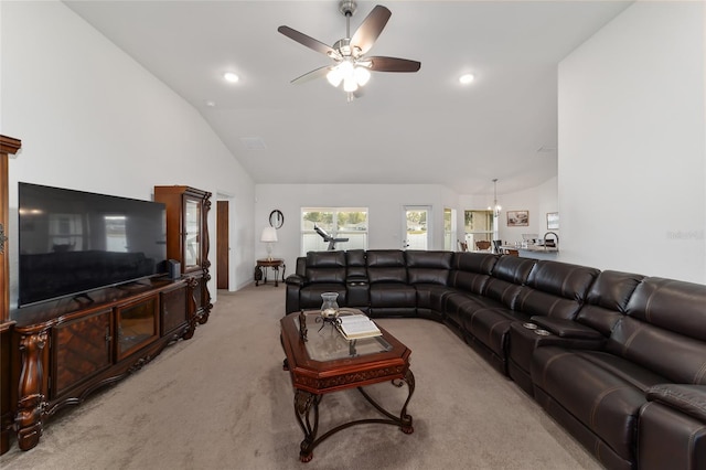 living room with high vaulted ceiling, ceiling fan, and light colored carpet