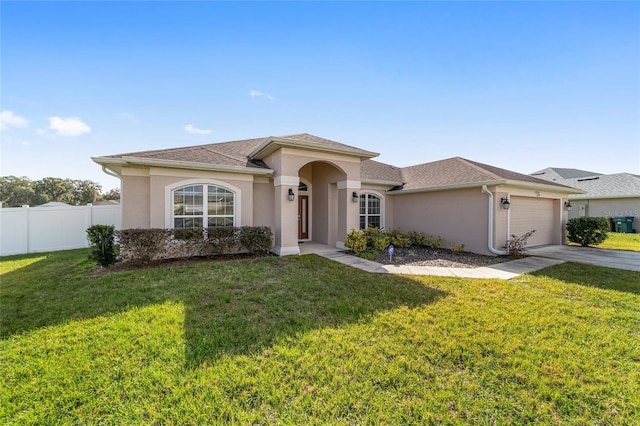 view of front of home with a front lawn and a garage