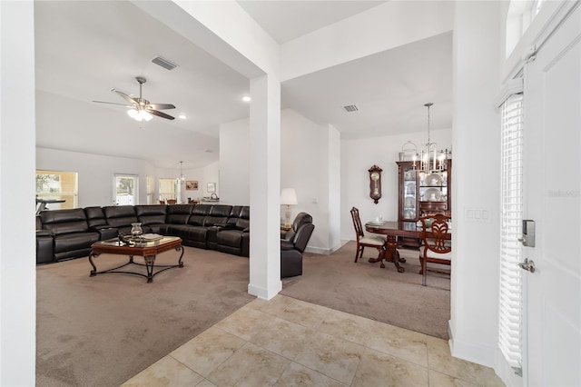 living room with light carpet and ceiling fan with notable chandelier