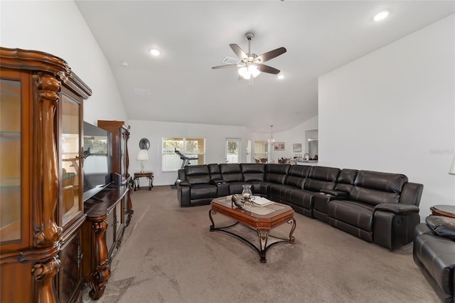 carpeted living room featuring ceiling fan and vaulted ceiling