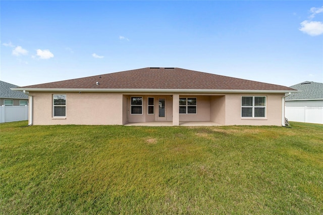 back of property featuring a lawn and a patio