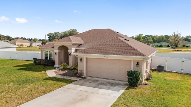 view of front facade featuring central AC unit, a front lawn, and a garage