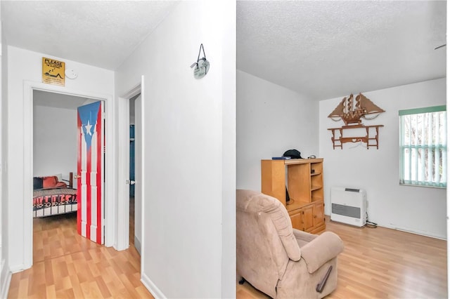 sitting room with a textured ceiling and light hardwood / wood-style floors