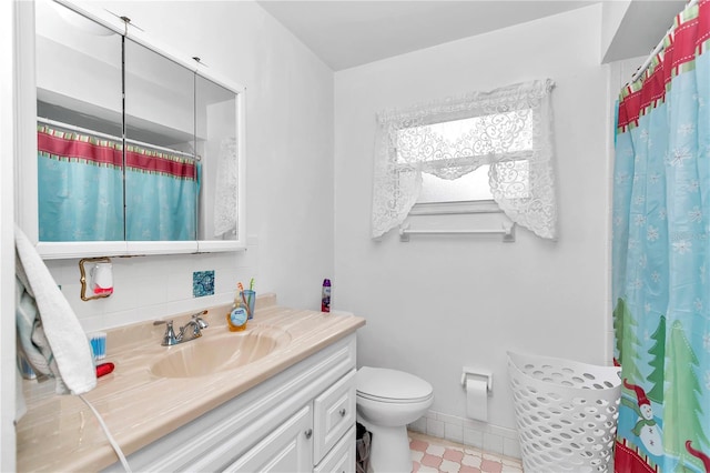 bathroom with toilet, tile floors, and vanity