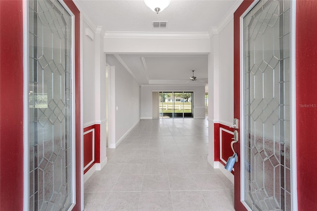 entrance foyer with crown molding, a textured ceiling, ceiling fan, and light tile floors