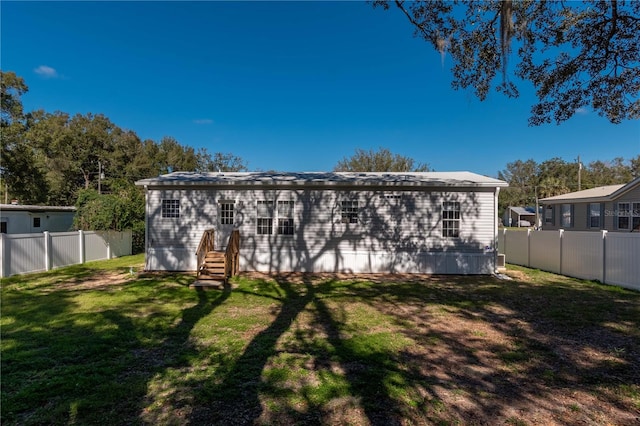 rear view of house featuring a lawn