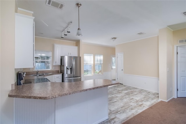 kitchen with white cabinetry, hanging light fixtures, stainless steel refrigerator with ice dispenser, kitchen peninsula, and light carpet