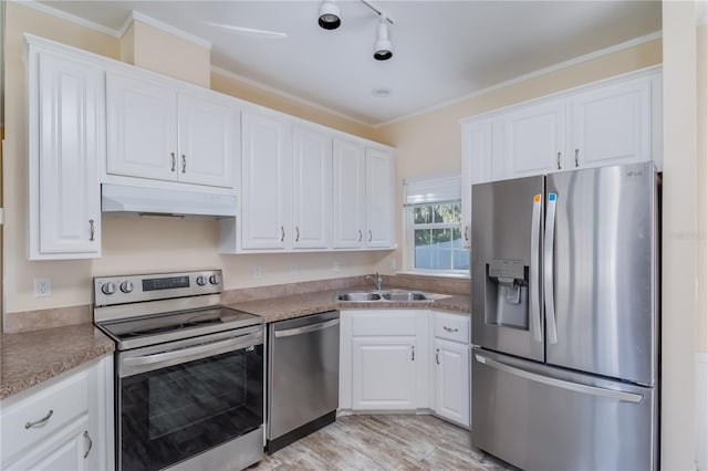 kitchen featuring white cabinetry, sink, stainless steel appliances, and ornamental molding