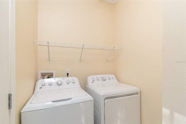 washroom with washing machine and dryer