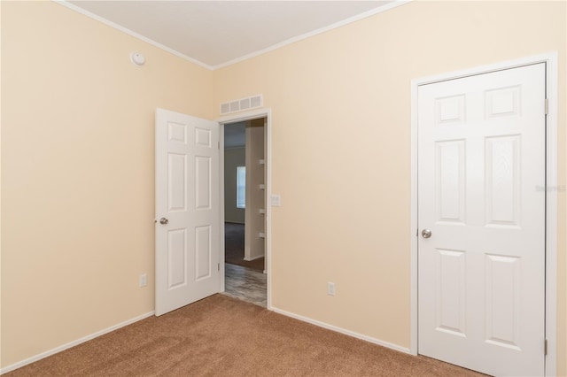 carpeted empty room with crown molding