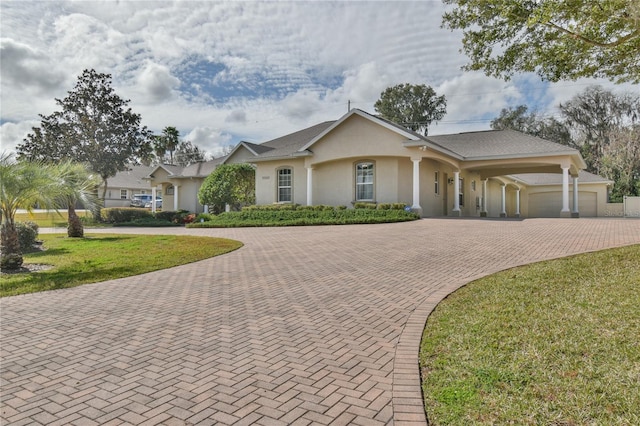 ranch-style house with a garage and a front yard