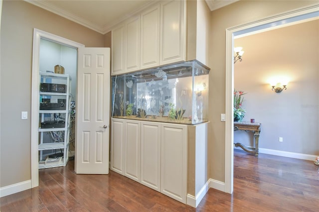 kitchen with ornamental molding, dark wood-type flooring, tasteful backsplash, and white cabinets