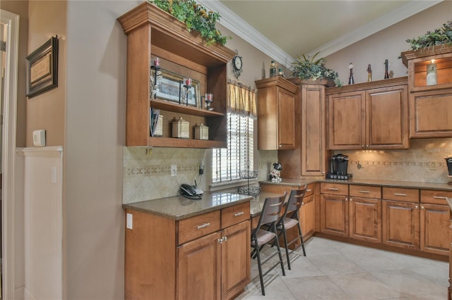 kitchen featuring ornamental molding, light tile patterned floors, decorative backsplash, and dark stone counters