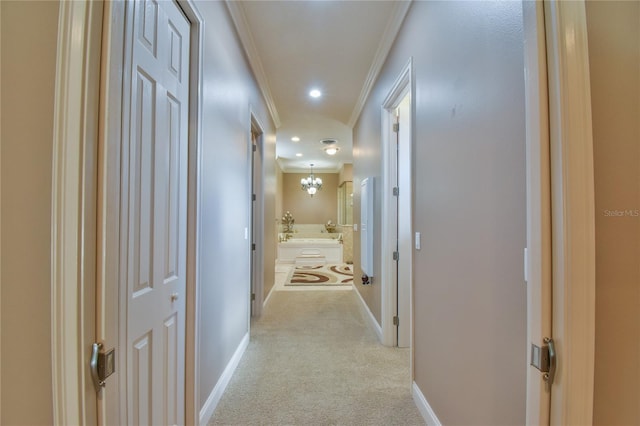 corridor featuring crown molding, light carpet, and a chandelier