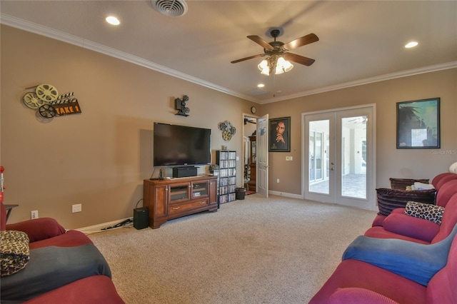 carpeted living room with crown molding, french doors, and ceiling fan