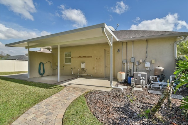 back of house featuring a yard and a patio area