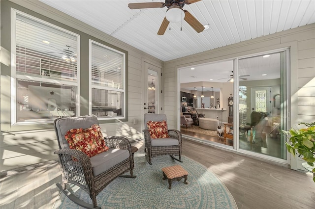 sunroom featuring ceiling fan