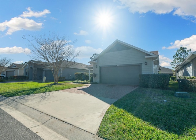 ranch-style house featuring a front yard and a garage