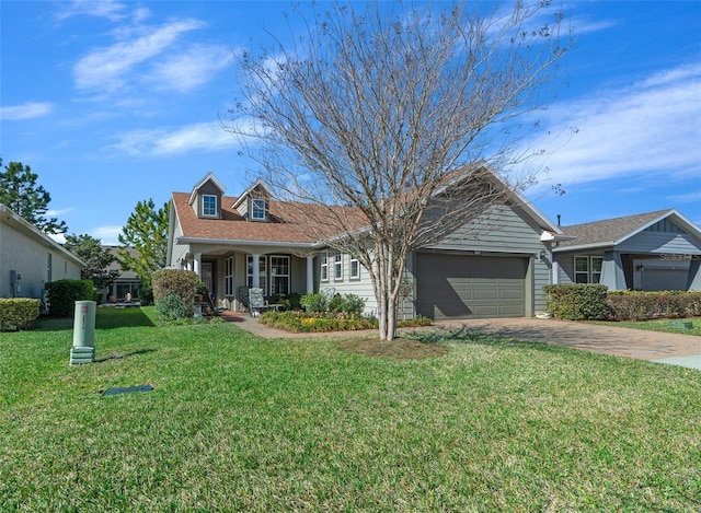 view of front facade with a front lawn, covered porch, and a garage