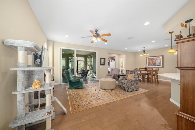 living room featuring wood-type flooring and ceiling fan