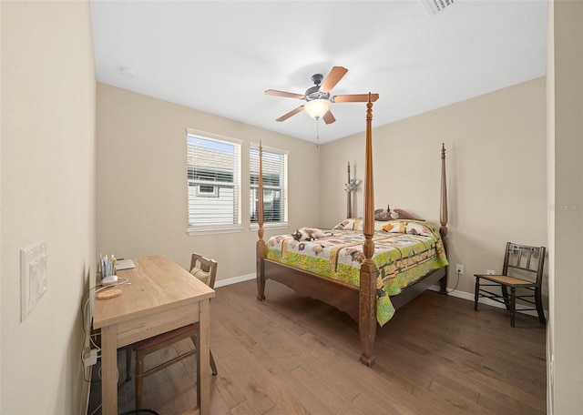 bedroom with ceiling fan and dark wood-type flooring