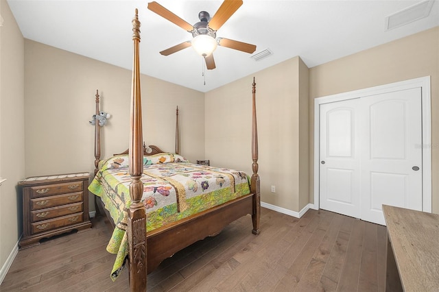 bedroom featuring dark hardwood / wood-style floors, a closet, and ceiling fan