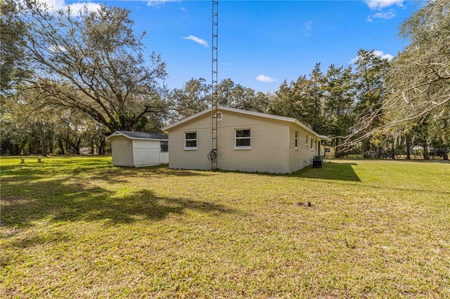 view of side of home featuring a storage unit and a lawn