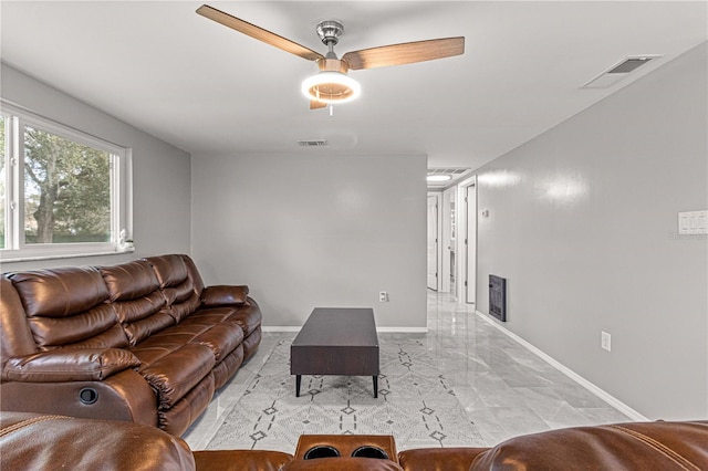 tiled living room featuring ceiling fan