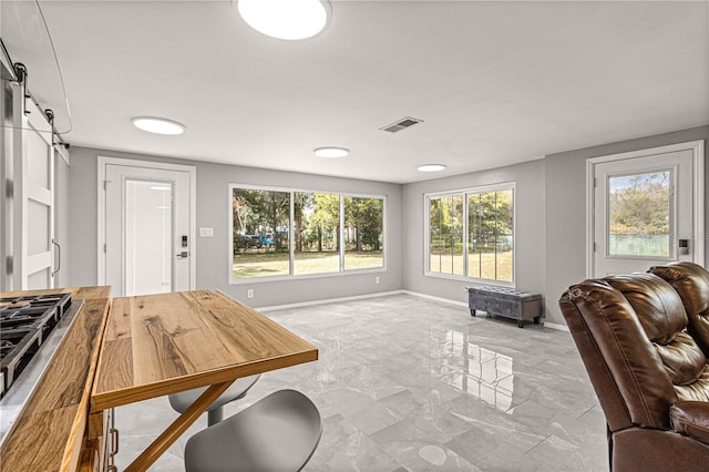 interior space featuring a barn door and light tile floors