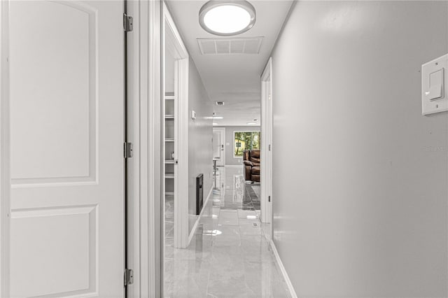 hallway featuring light tile flooring