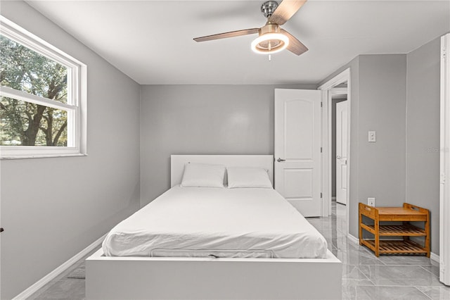 bedroom with ceiling fan and light tile floors