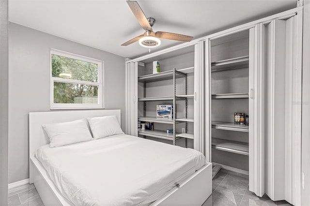 bedroom featuring light tile floors and ceiling fan