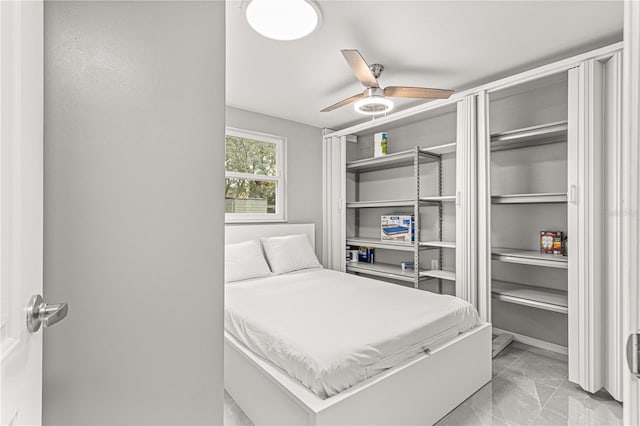 tiled bedroom with ceiling fan