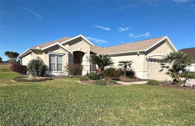 ranch-style house featuring a front yard and a garage