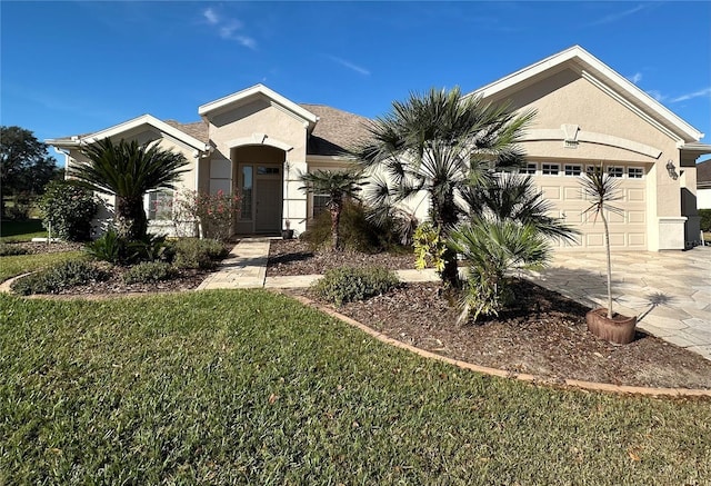 single story home with a front yard and a garage