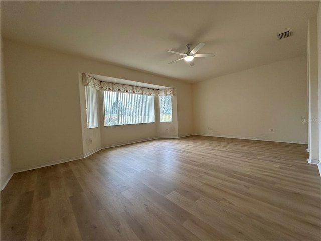 unfurnished room featuring light wood-type flooring and ceiling fan