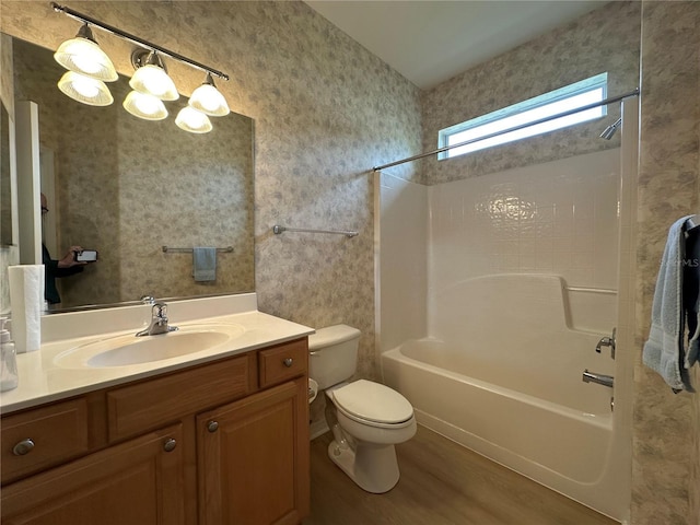 full bathroom featuring toilet, bathtub / shower combination, vanity, and hardwood / wood-style flooring