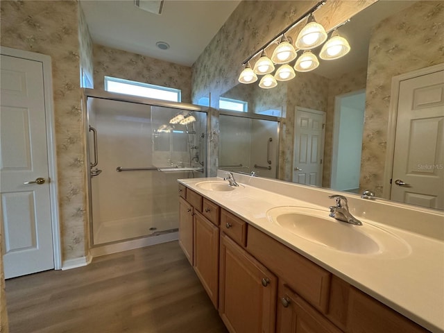 bathroom featuring vanity, wood-type flooring, and walk in shower